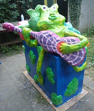 Polyester sculpture Ode to the earth by Twan de Vos, 3 frogs make music, accordion, guitar and wind instrument, singing about the beauty of their surroundings sing