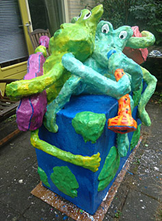 Polyester sculpture Ode to the earth by Twan de Vos, 3 frogs make music, accordion, guitar and wind instrument, singing about the beauty of their surroundings sing