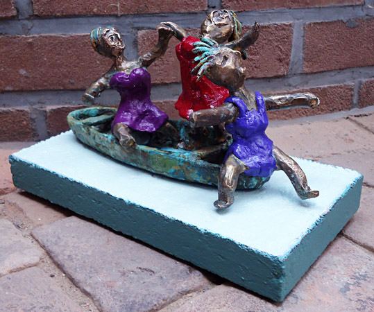 Painted bronze statue Pleasure Boating by Twan de Vos, three women dancing, singing and having fun on a boat