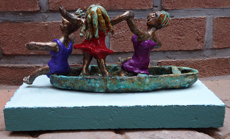 Painted bronze statue Pleasure Boating by Twan de Vos, three women dancing, singing and having fun on a boat
