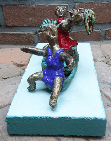 Painted bronze statue Pleasure Boating by Twan de Vos, three women dancing, singing and having fun on a boat